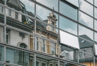 Old buildings reflected on modern facade